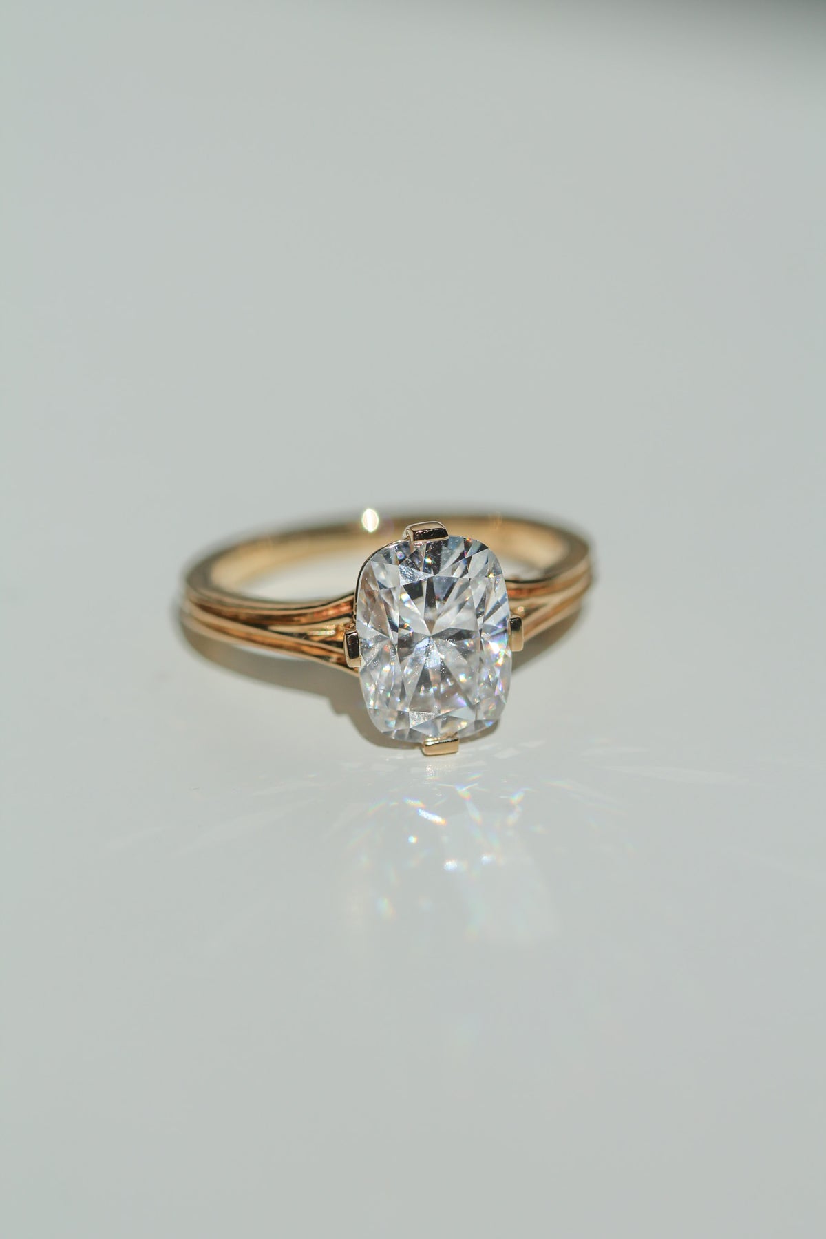 Brilliant cut elongated cushion diamond ring on a white background (view 3)