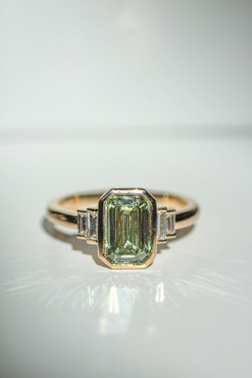 emerald cut green diamond in an art deco setting with white diamond baguette side stones (view 2)
