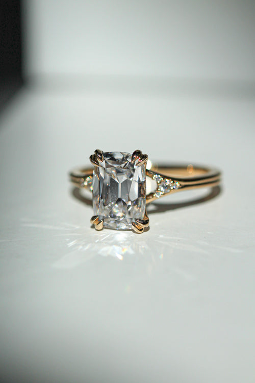 old mine cut elongated cushion diamond in a yellow gold engagement ring